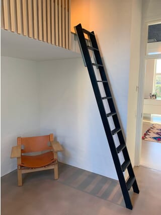 Dolle Straight Flight Wooden Loft Ladder (Black) being used with a Ladder Slide System